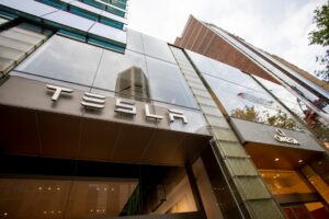 A certified solar technician carefully inspecting integrated solar tiles on a sleek modern roof - how tesla solar roof