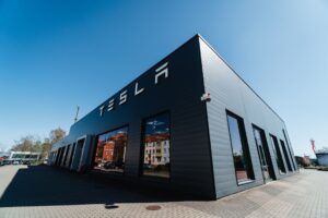 Tesla Solar Roof on a modern home with sunlight hitting solar tiles
