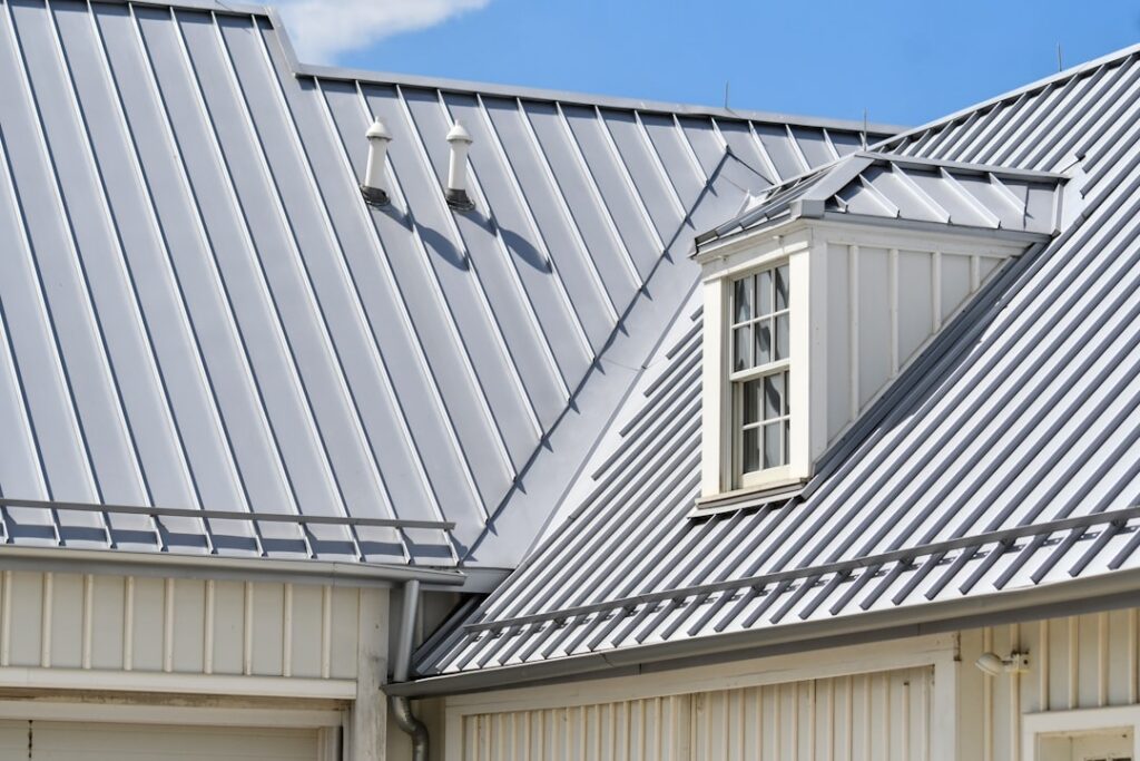 metal roof vs asphalt shingles on a modern residential home