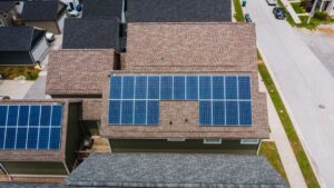 solar panels on residential roof with blue sky and sunlight