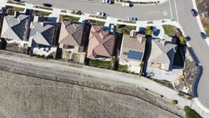 solar panels on a California home with blue sky and clean energy backdrop
