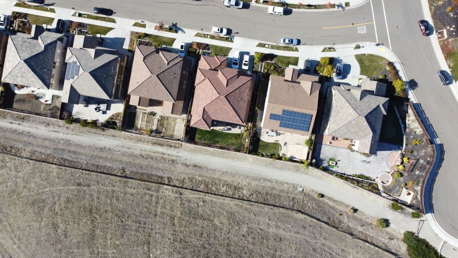 solar panels on a California home with blue sky and clean energy backdrop